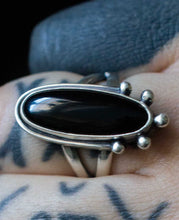 Load image into Gallery viewer, Handcrafted Black Onyx Dharma Ring with Sterling Silver Details made with Old World Artisan Silversmithing. Handcrafted in Colorado
