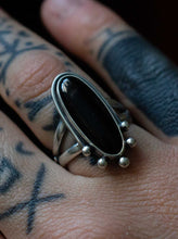 Load image into Gallery viewer, Handcrafted Black Onyx Dharma Ring with Sterling Silver Details made with Old World Artisan Silversmithing. Handcrafted in Colorado
